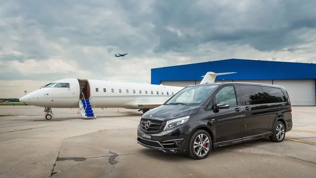 Black Mercedes-Benz V-Class beside a private jet on an airport apron